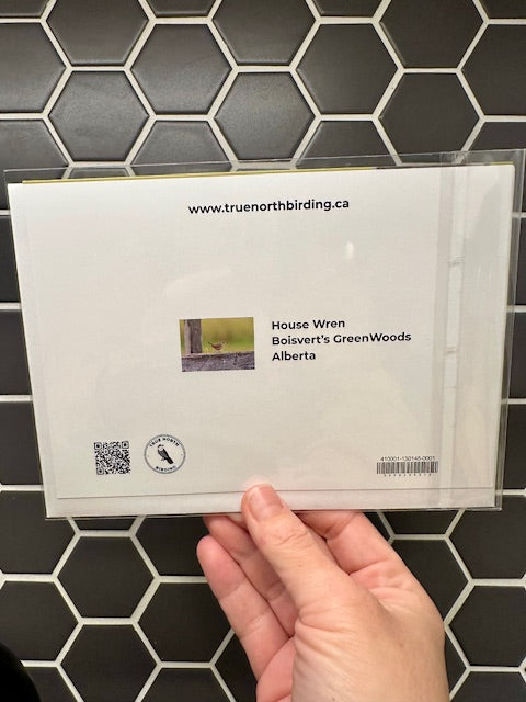 back of card held against a tiled wall